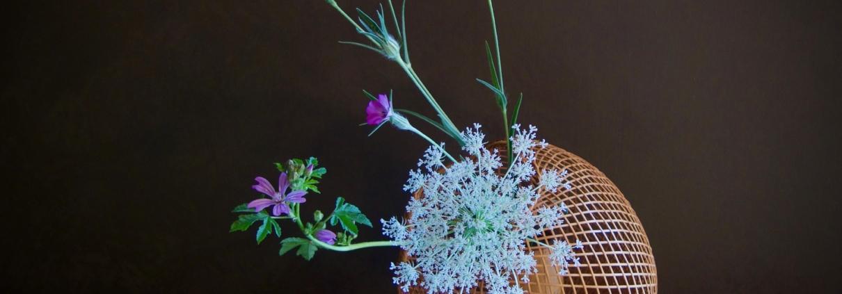 Ikebana di primavera con fiori e erbe di campo